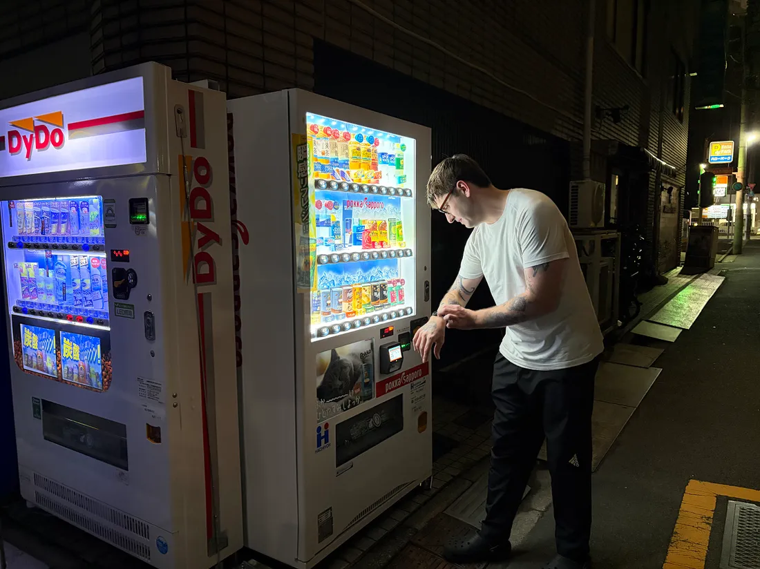 Person getting an item from a vending machine in Japan