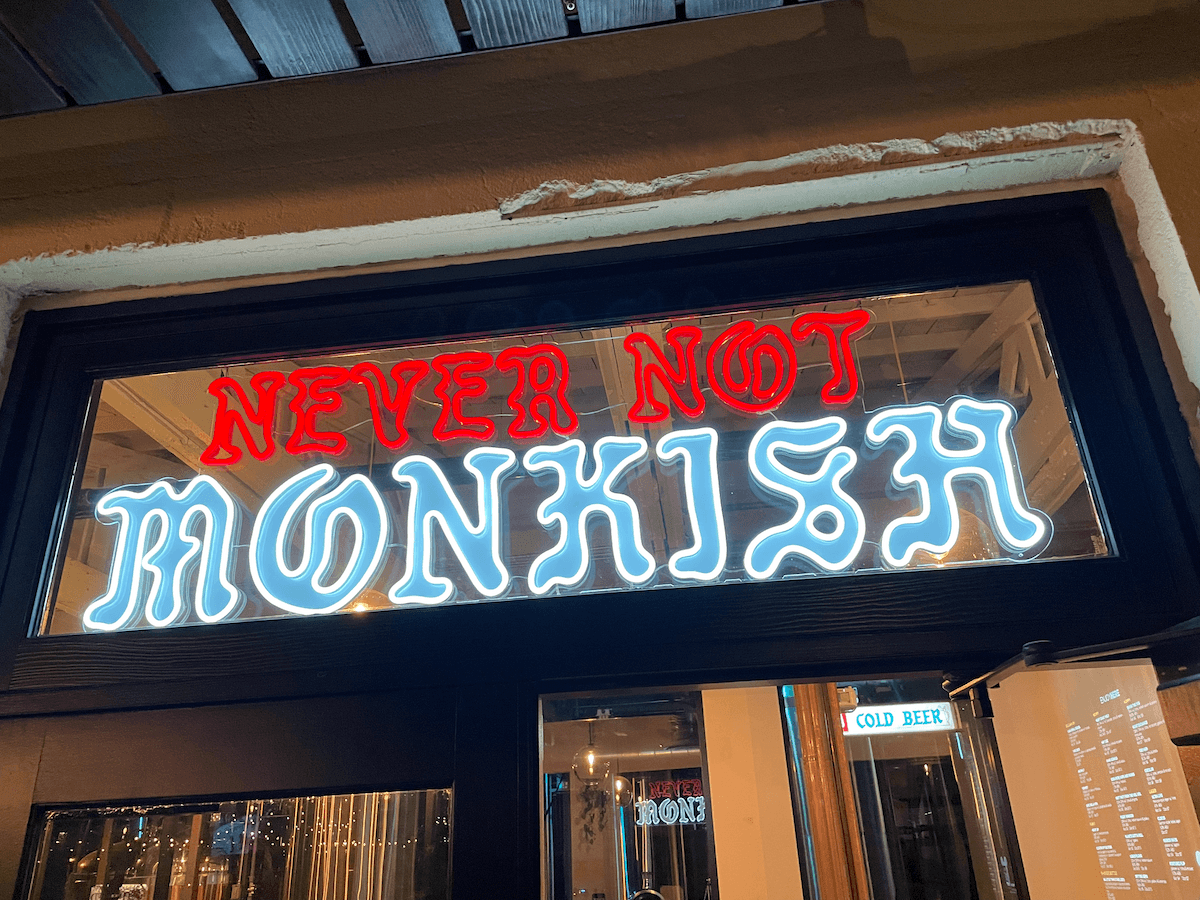 Neon sign that says "Never Not Monkish"