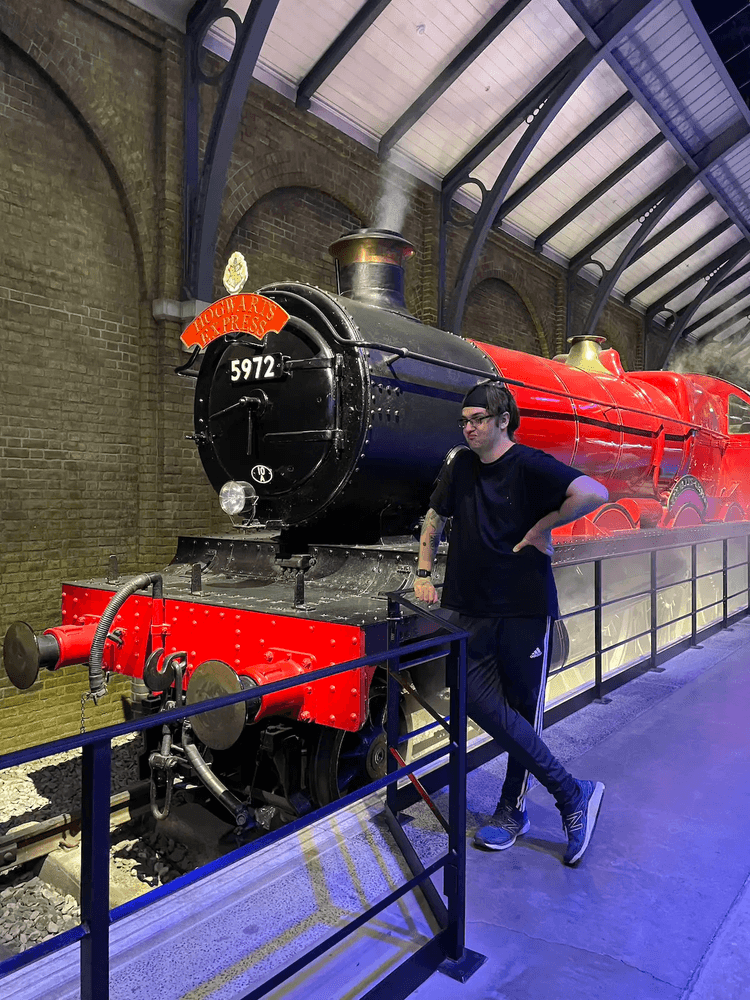 Person standing in front of a large scale model of Hogwarts