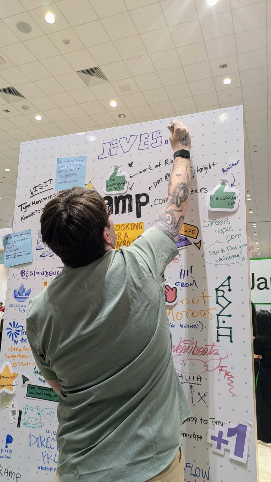 Person writing on a whiteboard.