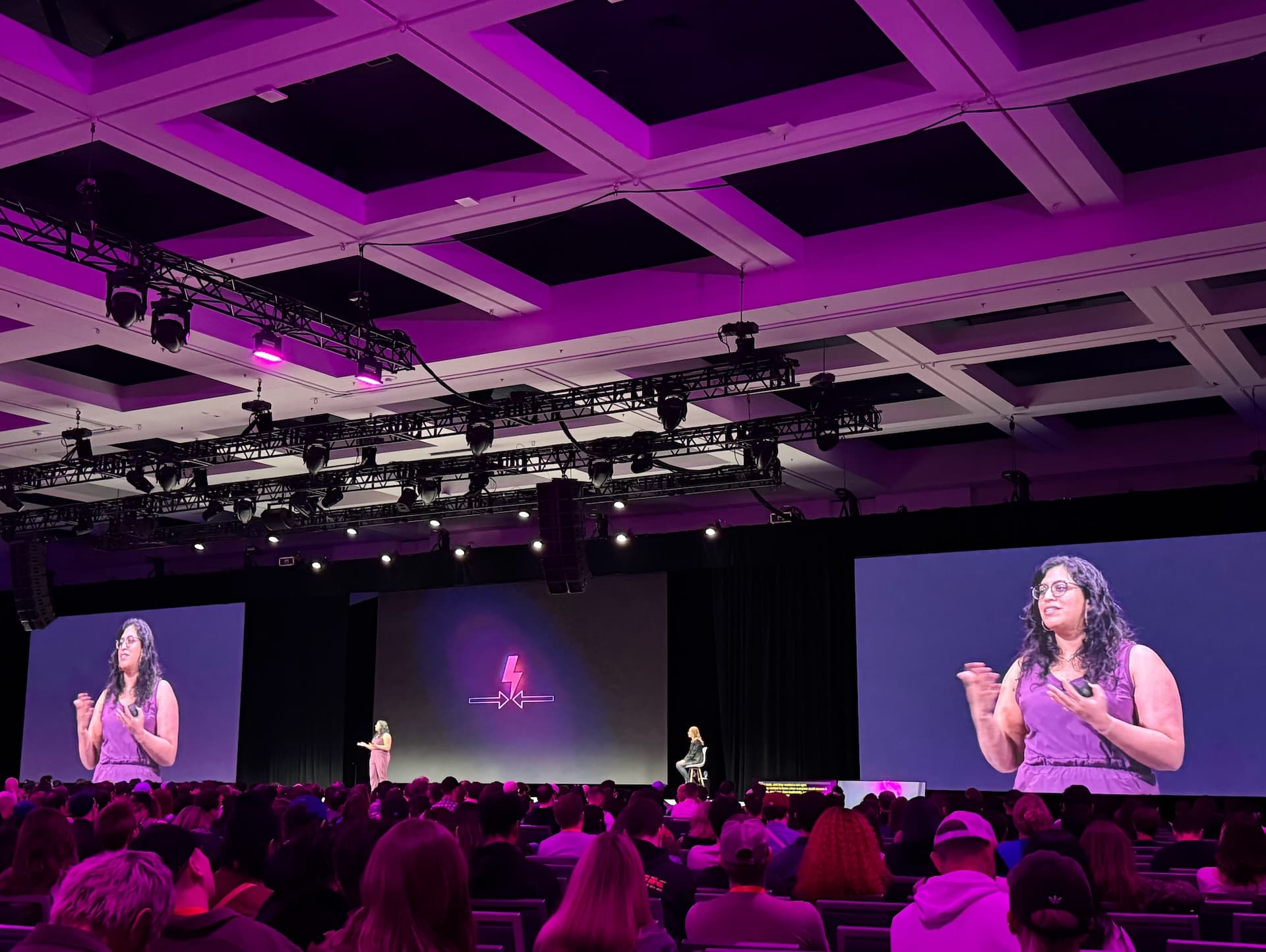 Person presenting to a crowd at a conference.