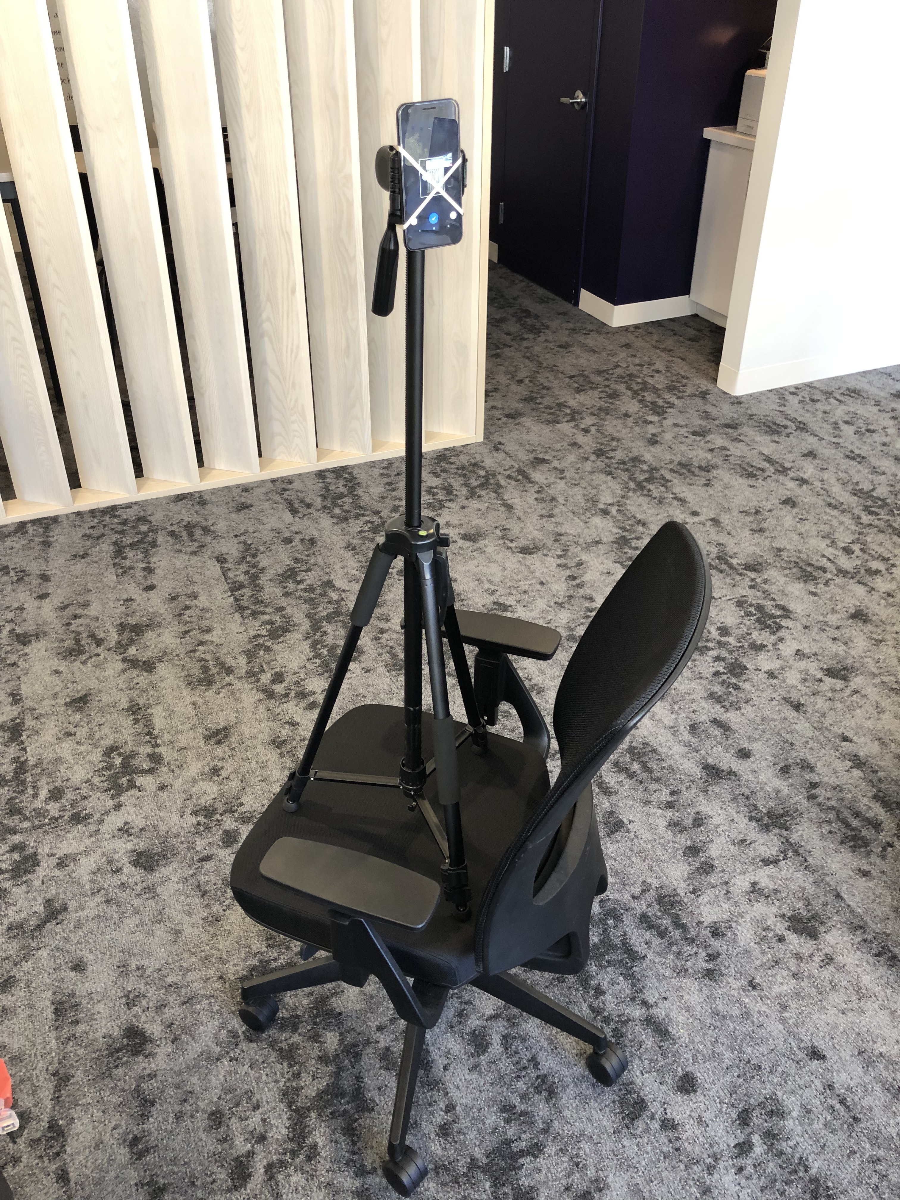 Chair with a tripod on it holding a
camera